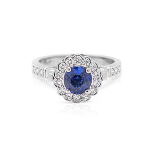 Platinum diamond and ceylon sapphire dress ring with a kiwi koru design
