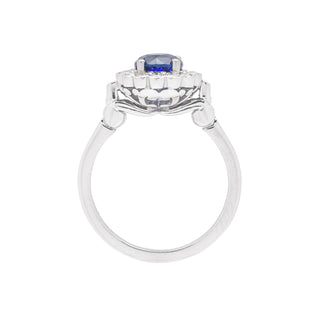 Platinum diamond and ceylon sapphire dress ring with a kiwi koru design - side view